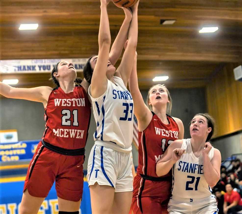 Stanfield's Destiny O'Neill (33) and Maggie Sharp (21) battle inside against Weston-McEwen. (Photo by Kathey Aney)