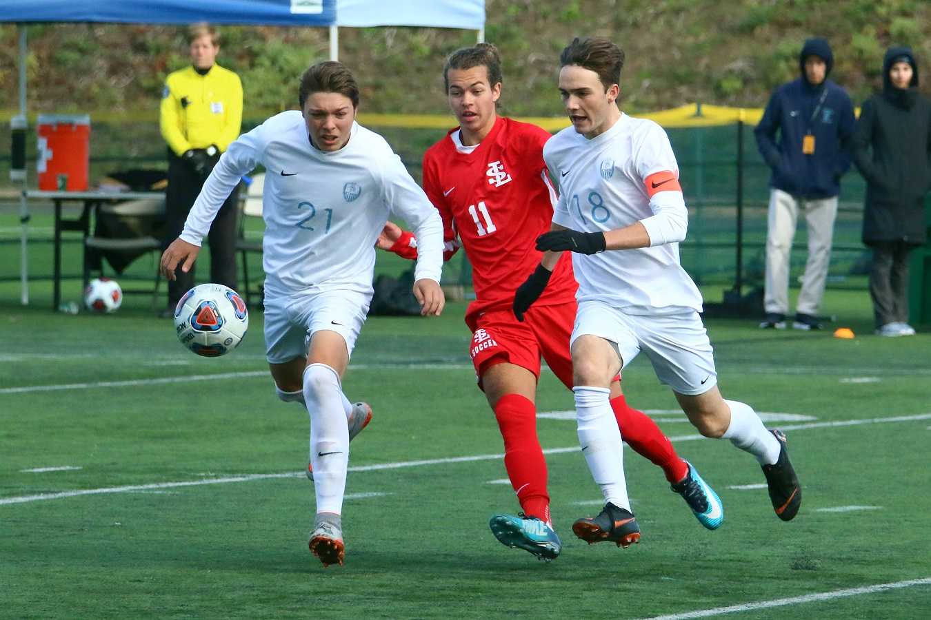 Corvallis' Spencer Vingelen (21) and Avery Whipple (18) pursue the ball against La Salle Prep's Luke Strange. (Ted Miller)