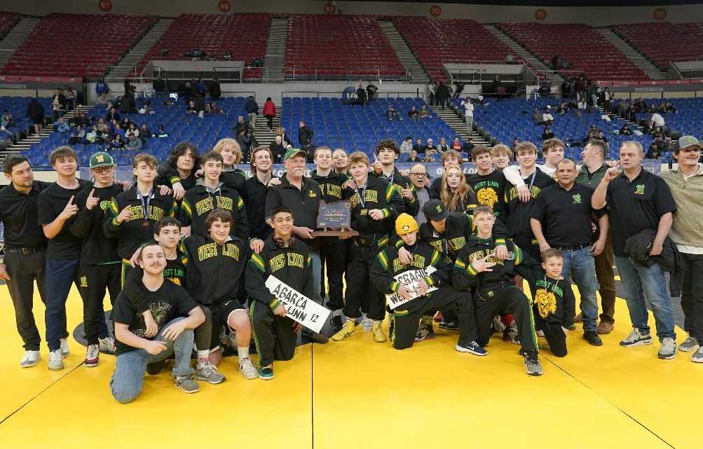 West Linn's wrestling team celebrates its first state championship Sunday at Veterans Memorial Coliseum. (Photo by Jon Olson)