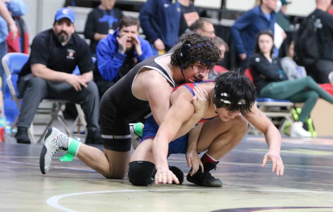 Wilsonville's Austin Sprecher (top) defeated Churchill's Aidan-Michael Pangelihan by pin Saturday. (Photo by Jim Beseda)