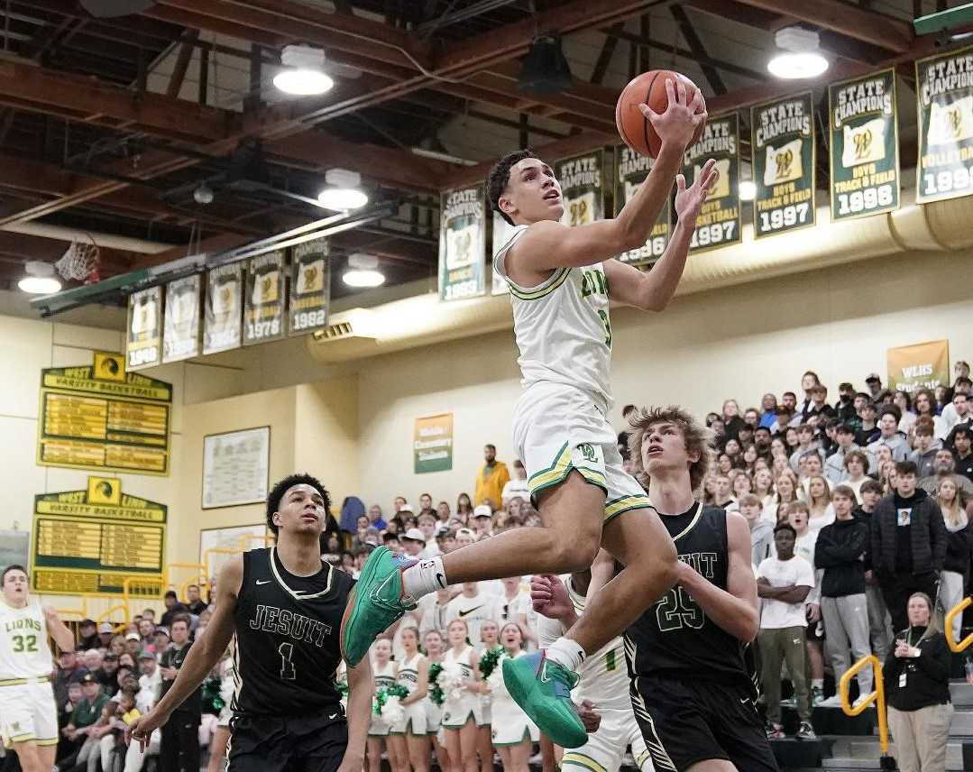 West Linn's Jackson Shelstad rises above Jesuit's Isaiah Crane (1) and Nico Rafalovich (25) on Saturday. (Photo by Jon Olson)