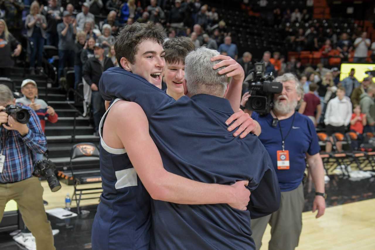 Kallen Gutridge embraces Wilsonville coach Chris Roche after the completion of another championship run (Greg Artman)