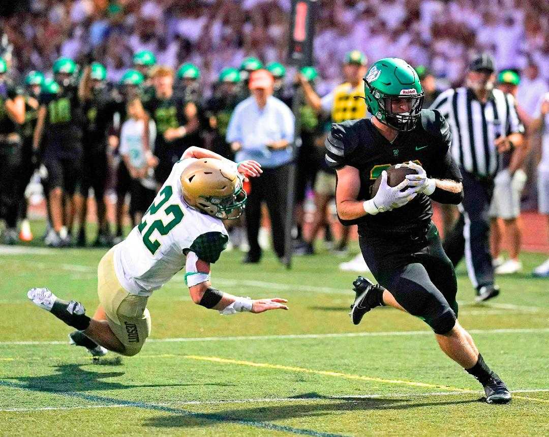 West Linn's Ryan Vandenbrink (right) has a bigger role at running back after an injury to Hudson Hardy. (Photo by Jon Olson)