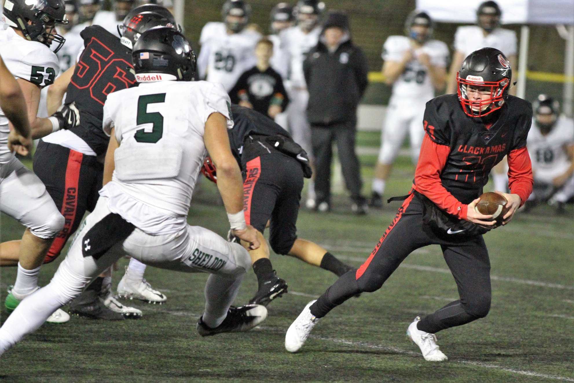 Sheldon's Patrick Herbert (5) chases down Clackamas quarterback Austin Atkeson. (Clackamas Touchdown Club)