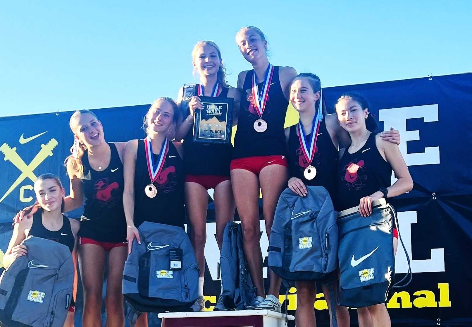 Lincoln's girls team celebrates its first-place finish Saturday in the Nike Hole in the Wall Invitational. (Courtesy photo)