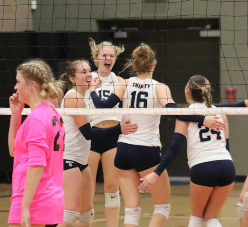 Kiya Young, Lexi Valentine, Ava Elliott and Malia Hernandez of Trinity Lutheran celebrate Elliott's kill