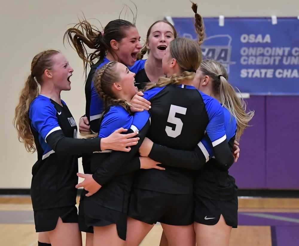 Crane's players celebrate a point during Friday's semifinal win over Umpqua Valley Christian (Andre Panse)