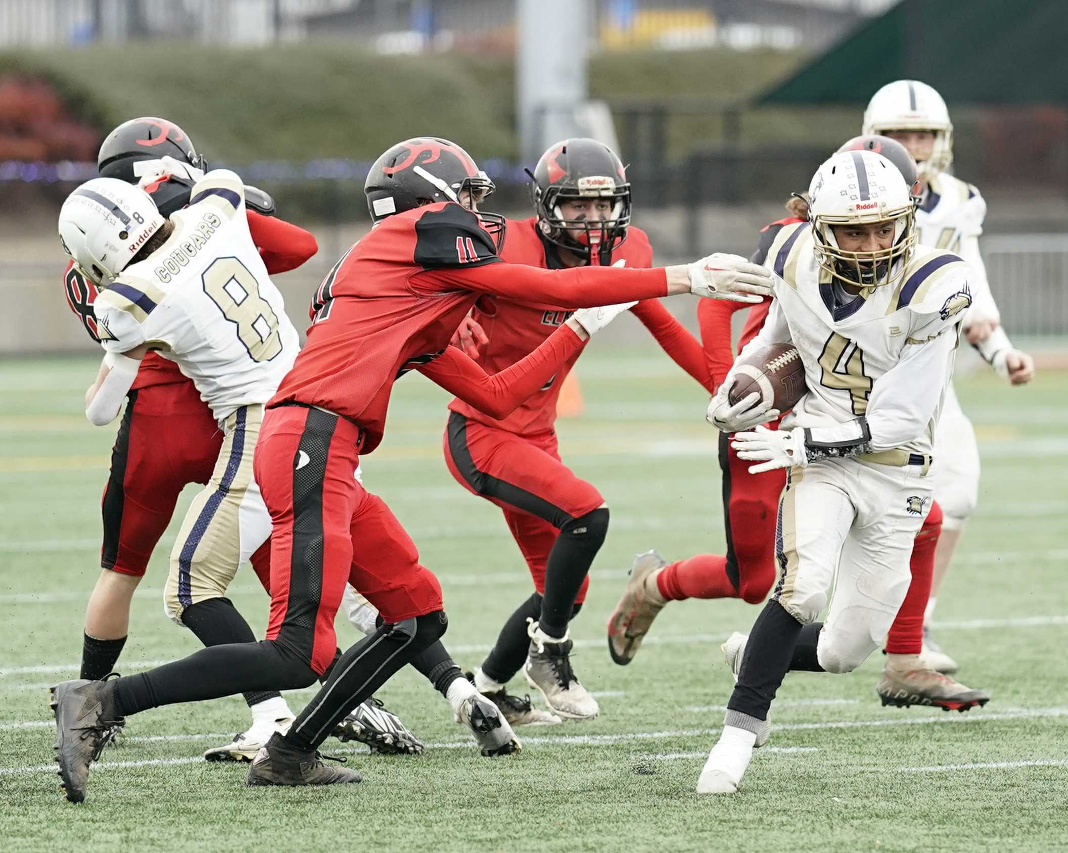 Echo's Sam Wyse (4) cuts past Elkton defenders during Saturday's semifinal win at Hillsboro Stadium. (Photo by Jon Olson)