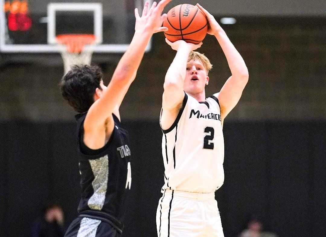 Mountainside junior Brayden Boe shoots over Tualatin's Zach Zuckerman in Thursday's nonleague game. (Photo by Jon Olson)