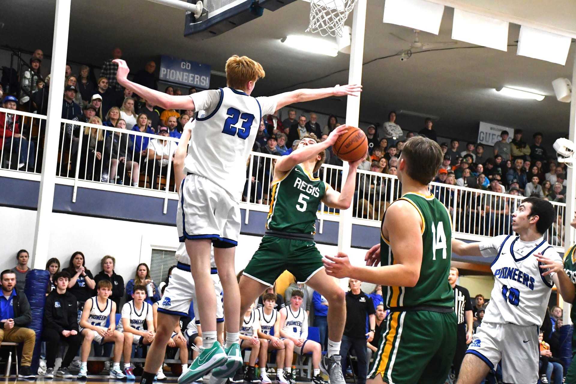 Regis' Rylan Bischoff (5) drives against Western Christian's Diggs Sladek (23) on Friday. (Photo by Jeremy McDonald)