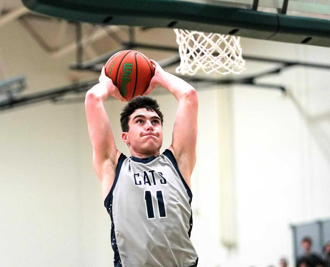 Wilsonville senior Kallen Gutridge dunks for two of his 22 points in Friday's NWOC win at Putnam. (Photo by Jon Olson)