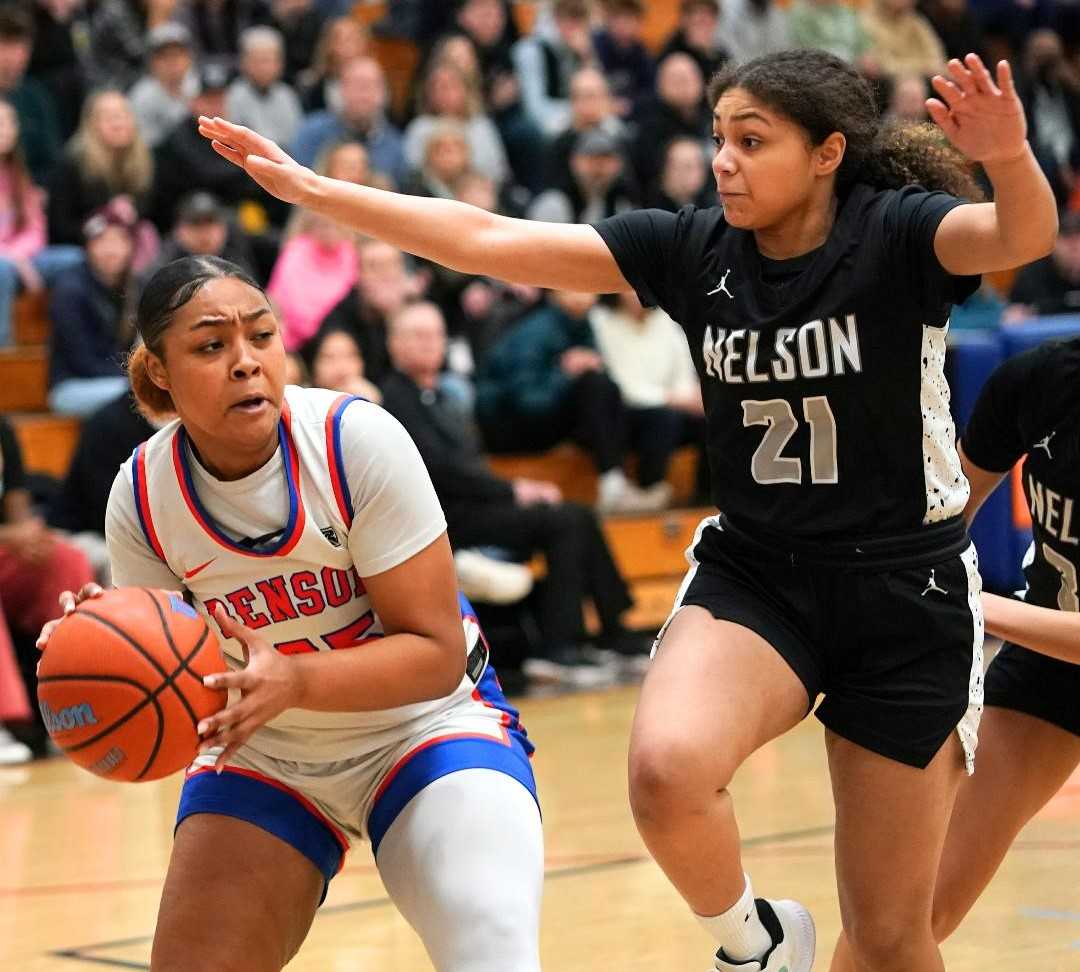 Benson's Samarah Massey moves toward the basket against Nelson's Tatiana Harris on Saturday. (Photo by Jon Olson)