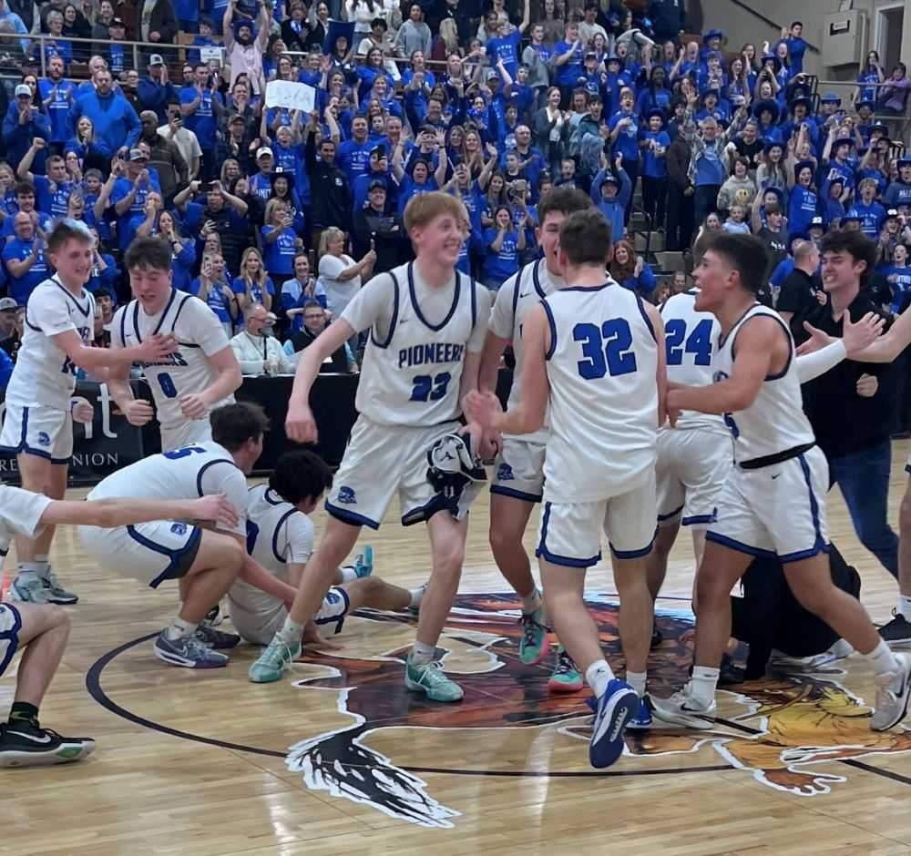 Diggs Sladek (23) and Gavin Hall (32) lead Western Christian's post-game celebration