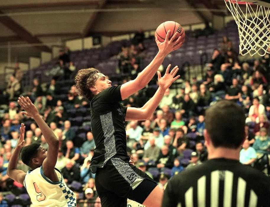 Tualatin senior forward Jaden Steppe drives to the basket in Wednesday's quarterfinal win over Barlow. (Photo by Jon Olson)