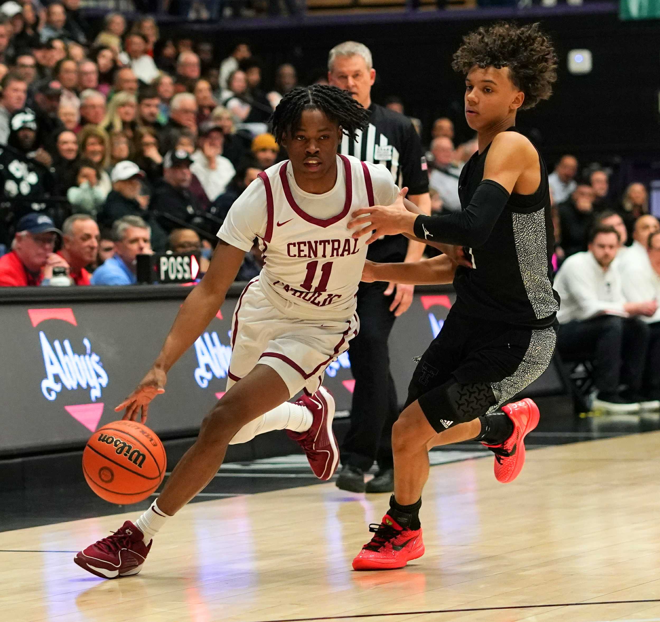 Central Catholic's Zamir Paschall (11) drives around Tualatin's Jemai Lake in Friday's semifinal. (Photo by Jon Olson)