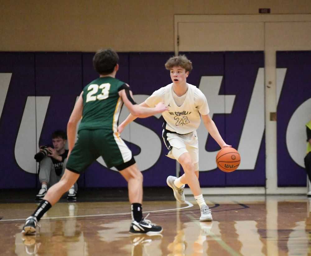 Jacob Boss, in white, works his way upcourt for Wilsonville against Lennon Freenleaf (Faith Mithmeuangnueua)