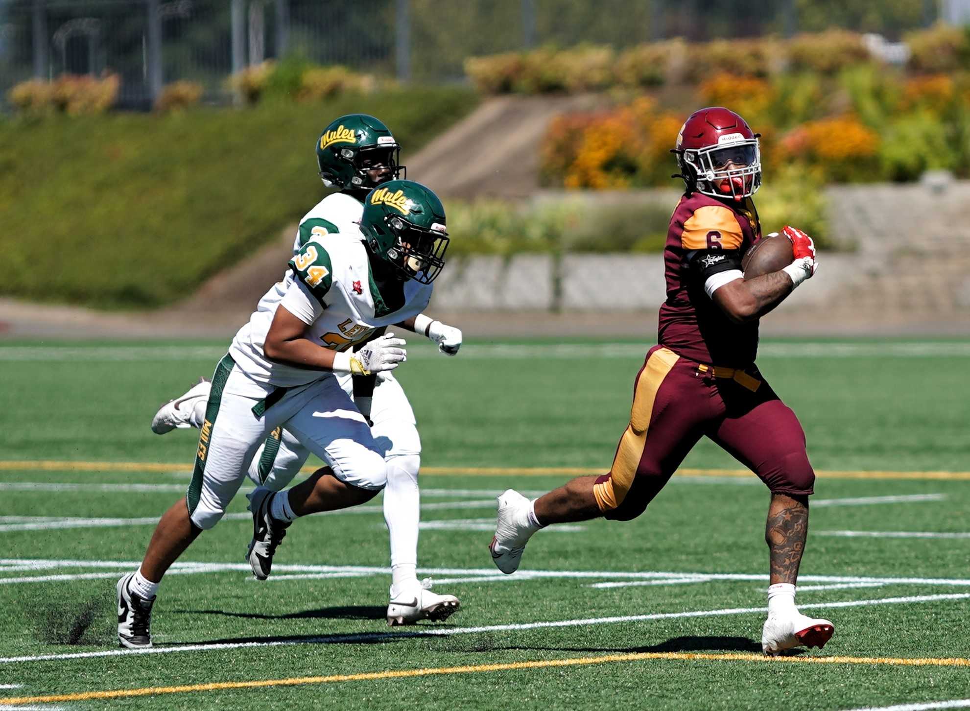 Central Catholic's Tyson Davis (6) sprints past Leilehua defenders on a 45-yard touchdown catch Friday. (Photo by J.R. Olson)