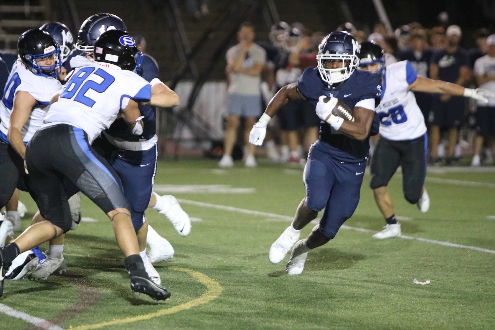 Lake Oswego's LaMarcus Bell finds running room during Friday's home game against South Medford. (Jim Beseda photo)