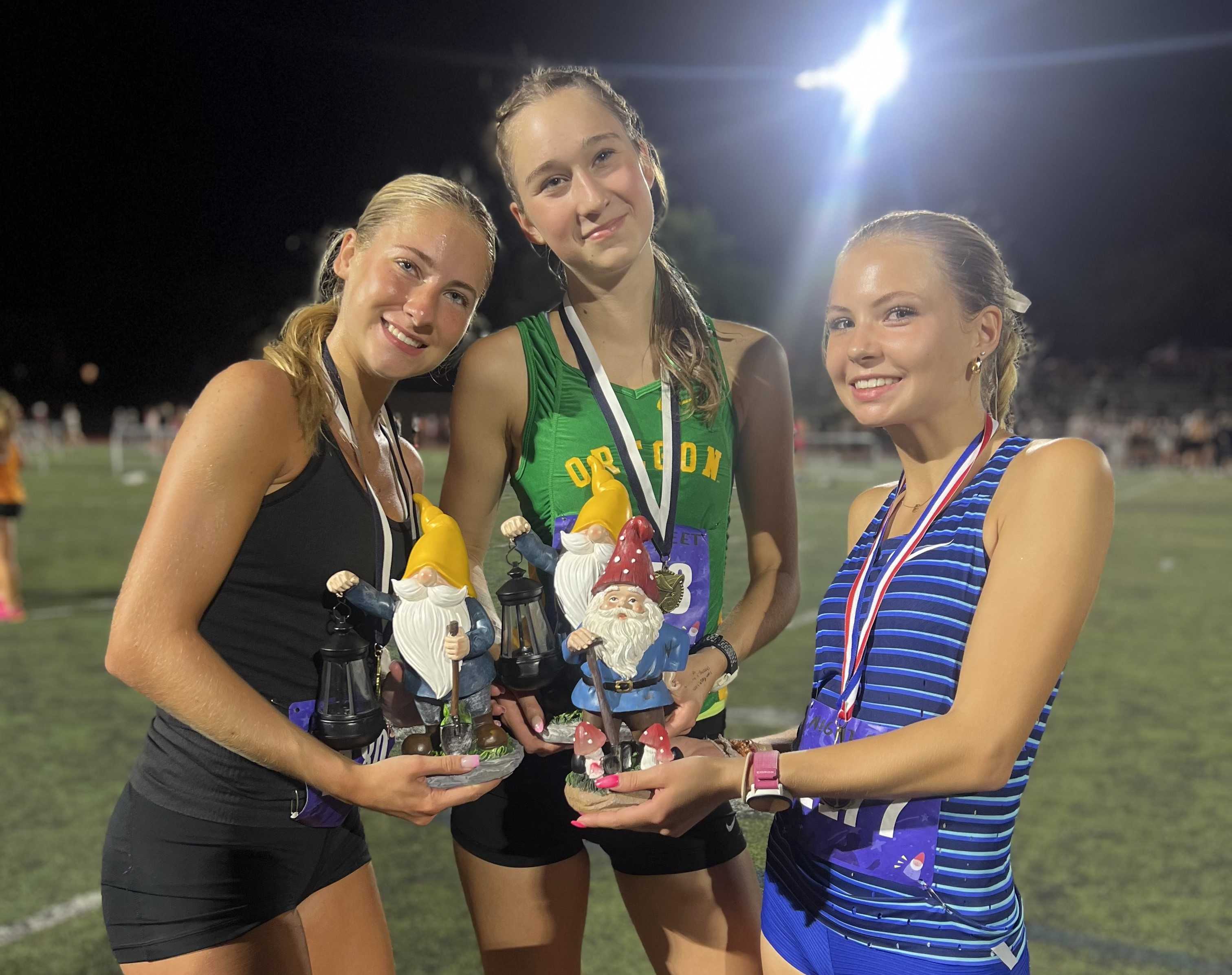 Lincoln's (from left) Sophia Malinoski, Elyse Henriksen and Ellery Lincoln brought home trophies from the Night Meet on Friday.