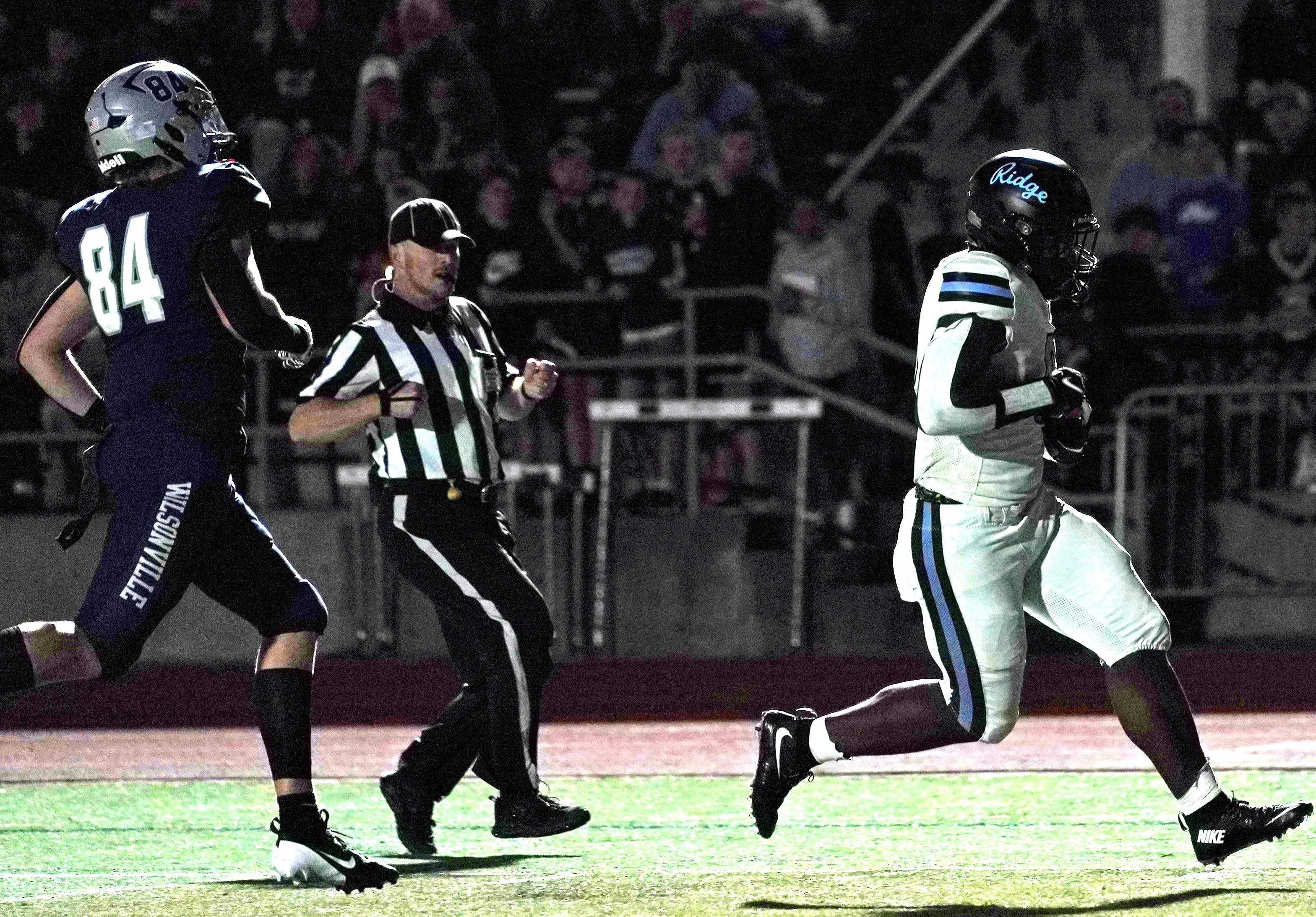 Lakeridge's Ansu Sanoe beats Wilsonville's Emmitt Fee to the end zone for a touchdown Friday night. (Photo by J.R. Olson)