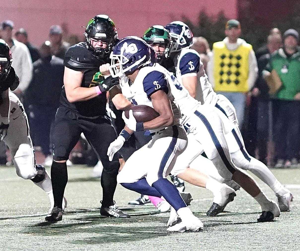 Lake Oswego's LaMarcus Bell cuts through the West Linn defense in Friday's Three Rivers League game. (Photo by J.R. Olson)