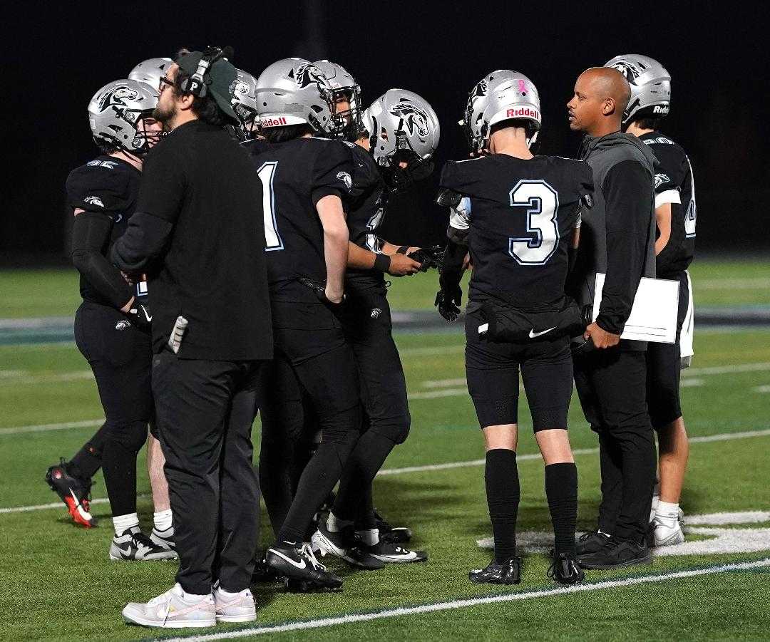 Mountainside coach Keanon Lowe goes over strategy with his players during Friday's win over Westview. (Photo by J.R. Olson)