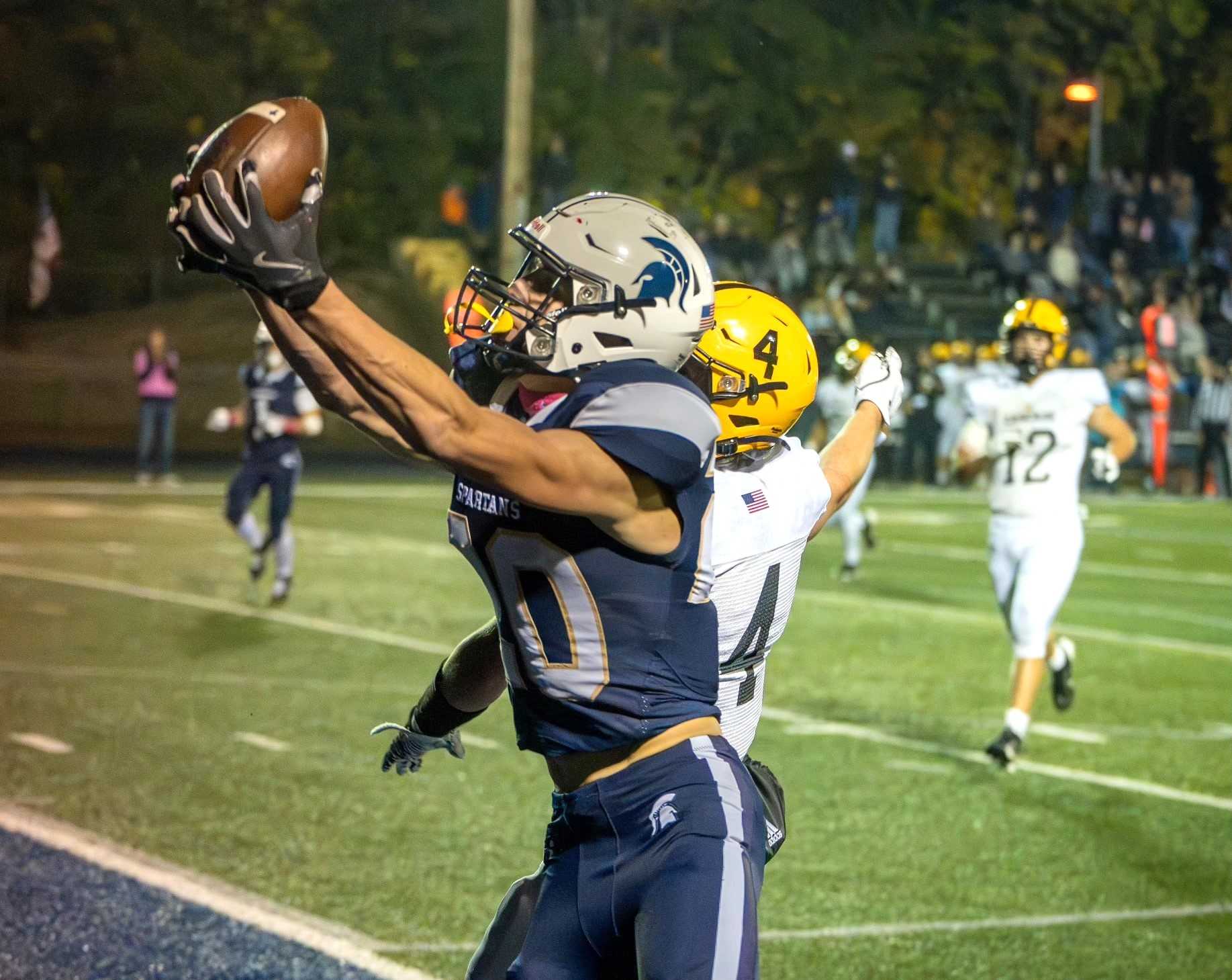 Marist Catholic's Aaron Bidwell catches a touchdown pass Friday against Cascade's Landon Knox. (Photo by Ty DePaoli)