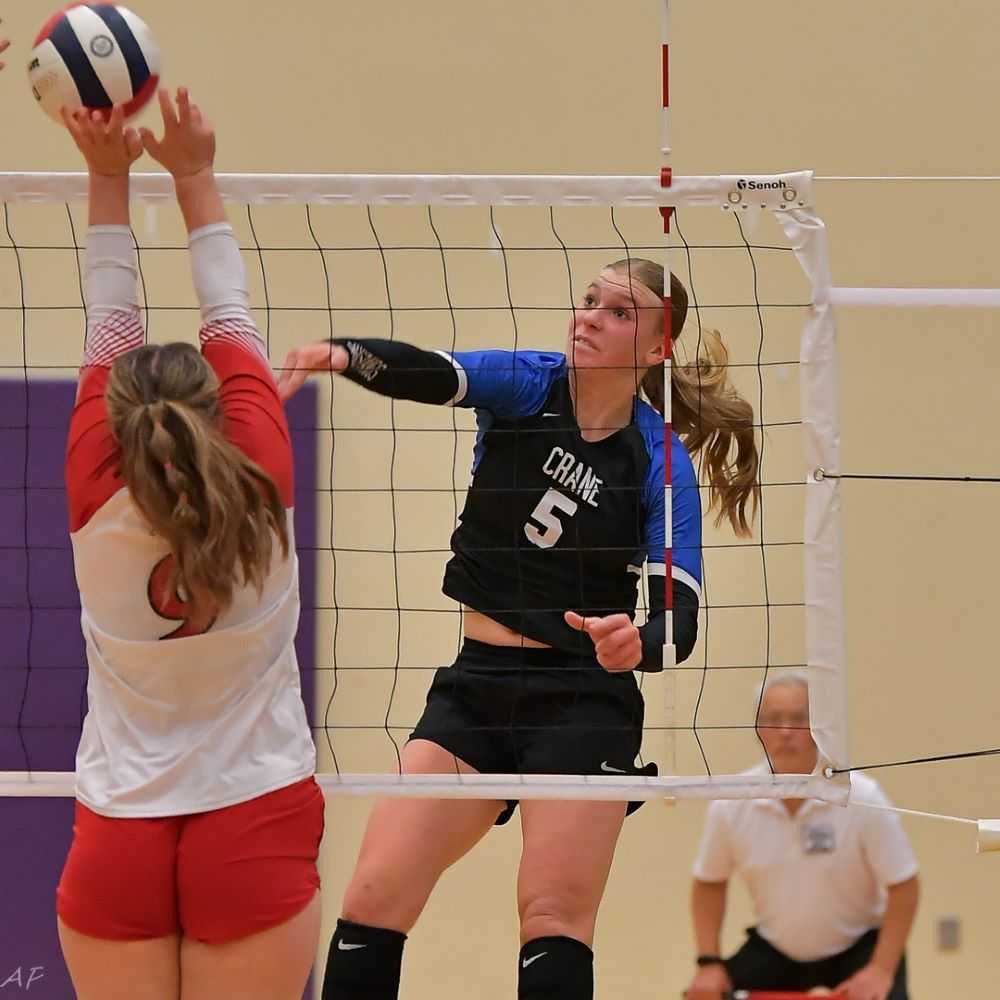 Crane sophomore Kaitlyn Seigner uses hands to score one of her match-high 13 kills in the 1A win over Union (Andre Panse)