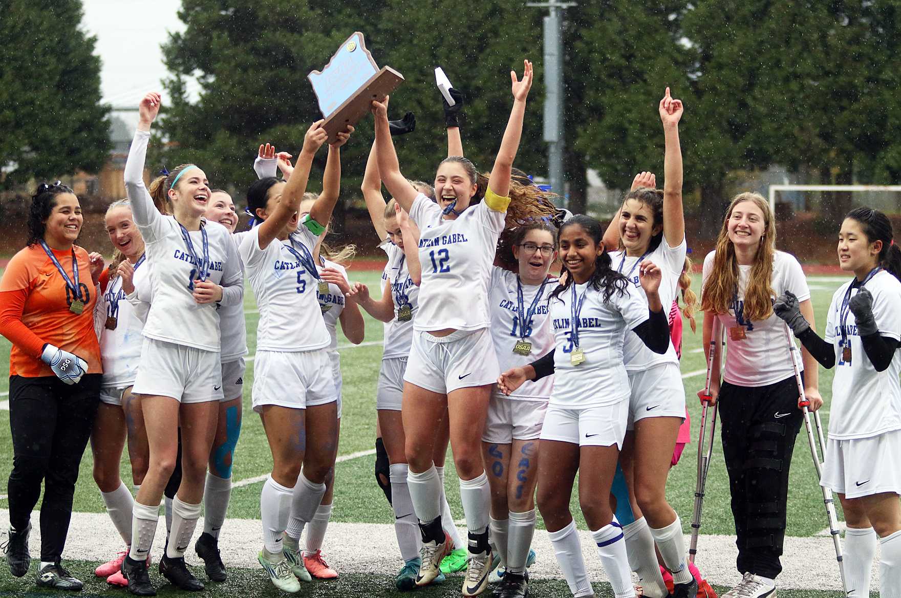 The Catlin Gabel girls soccer team celebrates following its win over Central Linn/East Linn Christian (photo by Dan Brood).