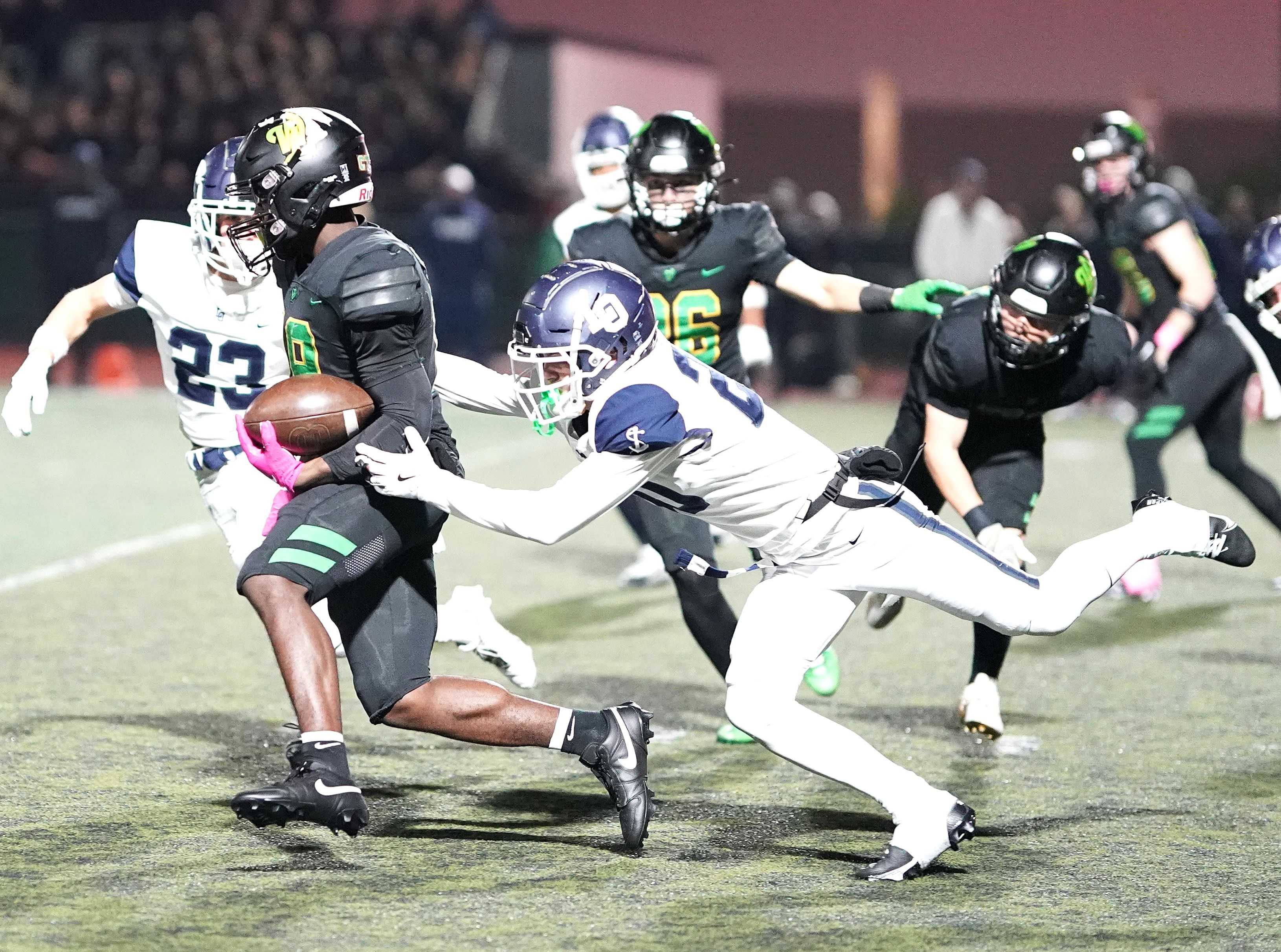 West Linn's Danny Wideman tries to escape Lake Oswego's Summit Cvitash in an Oct. 18 game. (Photo by J.R. Olson)