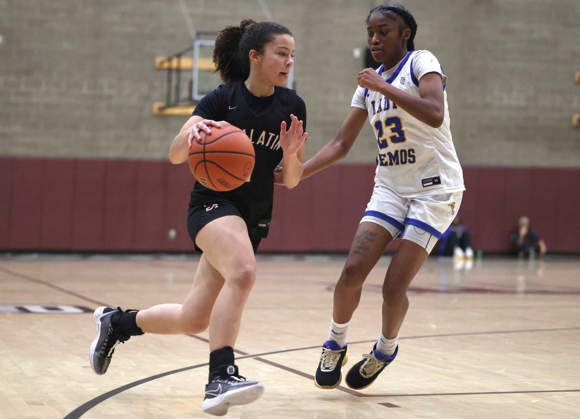 Tualatin's Love Lei Best drives against Jefferson's Charisma Johnson at the POA Holiday Classic. (Jonathan House/Valley Times)