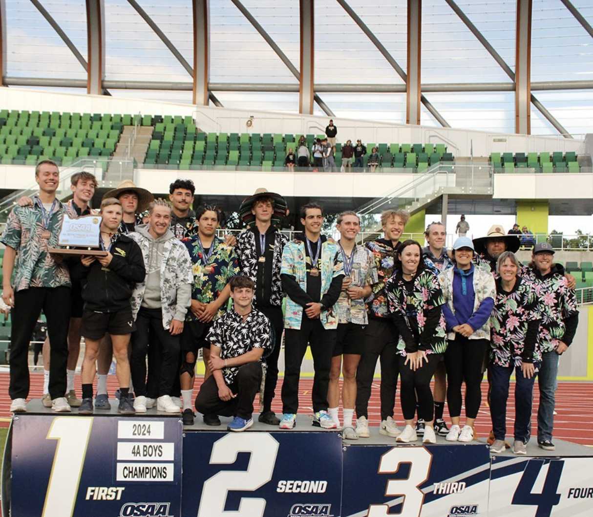 The boys team celebrates Crook County's first track and field state title in 2024