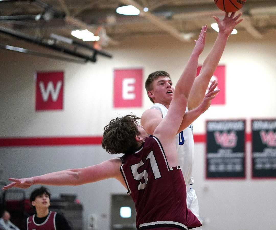 Crane's Cody Siegner, shooting over Dayton's Clyde Rosenberg, scored 17 points in Monday's nonleague game. (Photo by J.R. Olson)