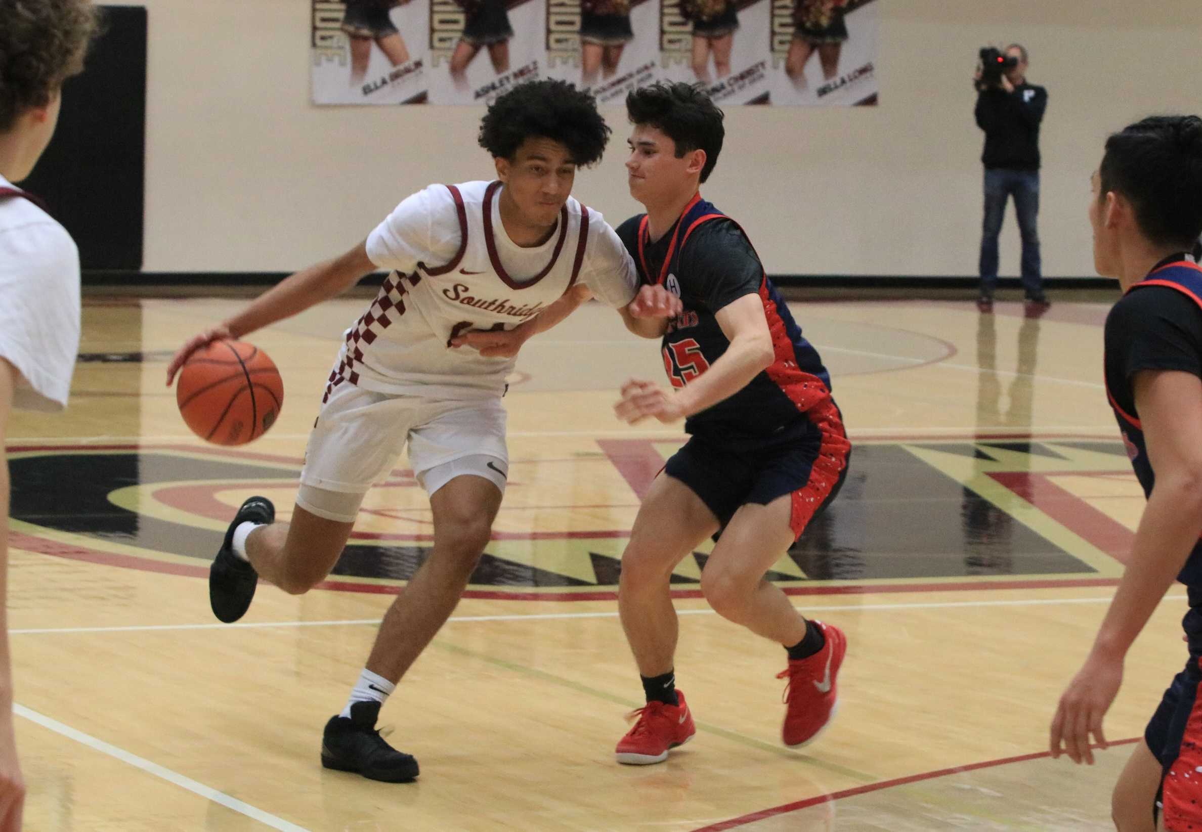 Southridge's Alonzo Hoff (14) runs into resistance from Westview's Lucas D'Haem (25) during Friday's Metro League showdown.