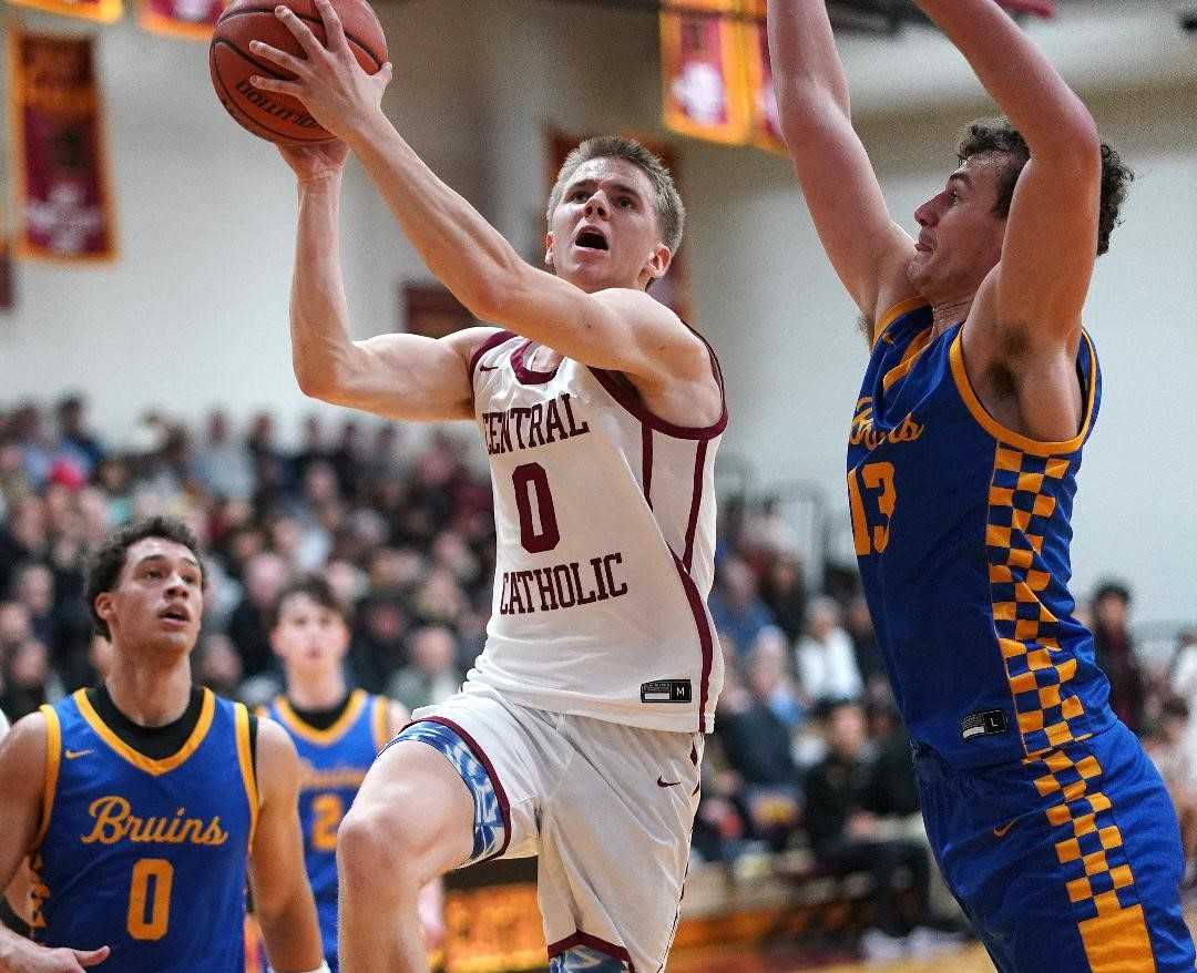 Central Catholic's Isaac Carr drives between Barlow's Mason Bierbrauer (13) and Jalen Atkins (0). (Photo by J.R. Olson)