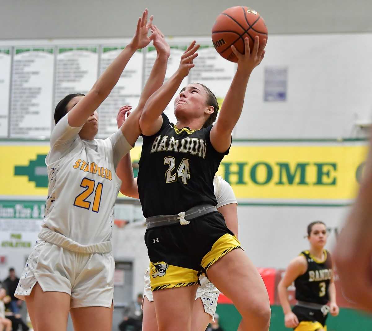 Bandon's Caitlyn Michalek shoots over Stanfield's Kenya Dovalina in Thursday's quarterfinal game. (Photo by Andre Panse)