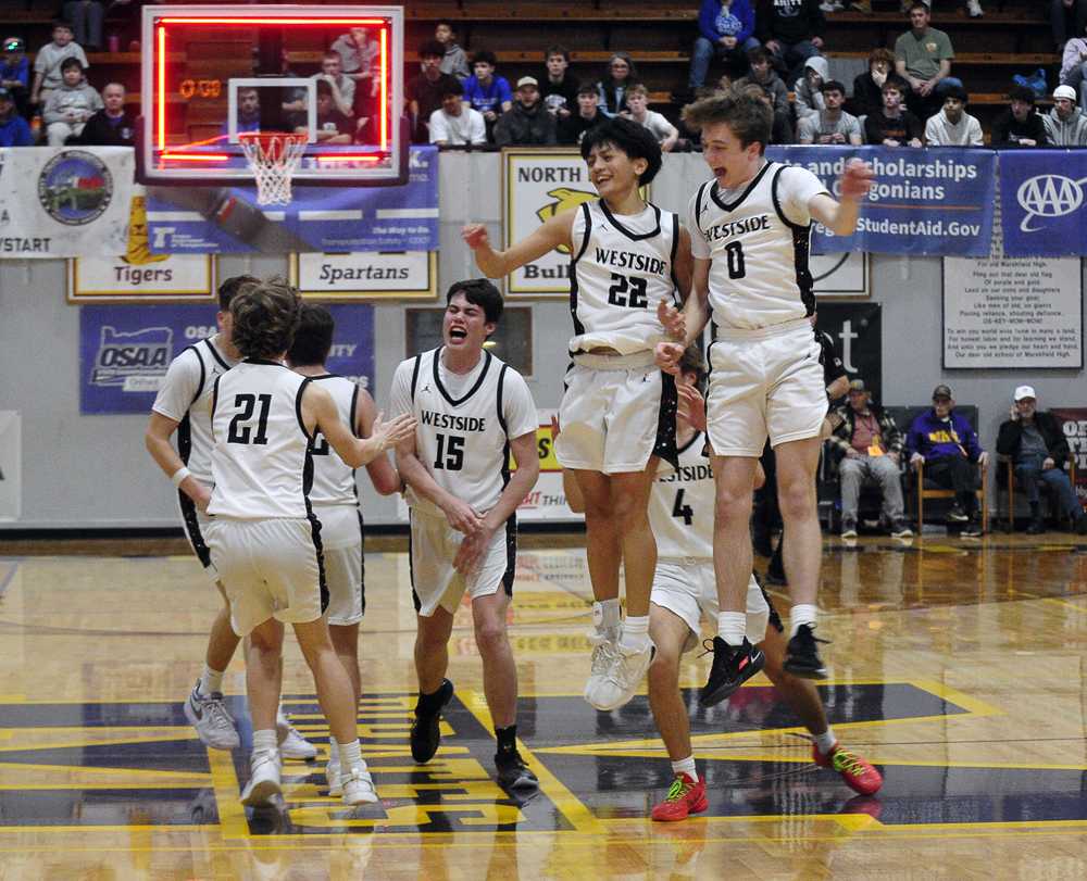 Cole Chiong (22) and Quinten Jaimet celebrate Westside Christian's comeback win with a victory leap (John Gunther)