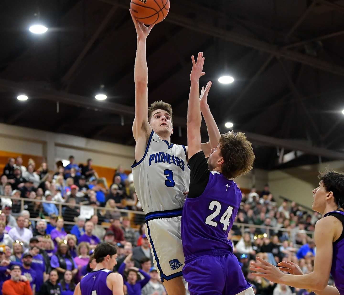 Western Christian's Caleb Halgren shoots over Portland Christian's Joseph Diesel on Saturday night. (Photo by Andre Panse)