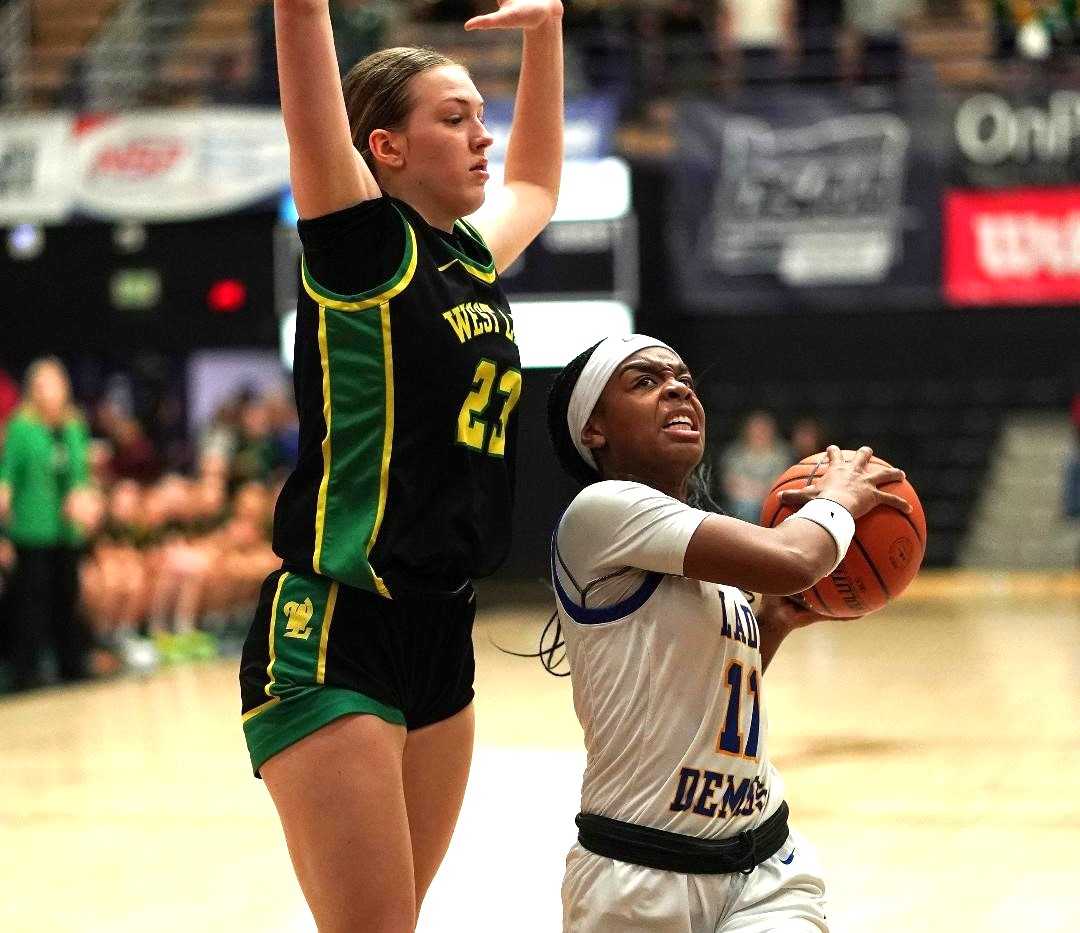 Jefferson's Abrianna Lawrence (11) drives against West Linn's Kinley Buse in Wednesday's quarterfinal. (Photo by J.R. Olson)