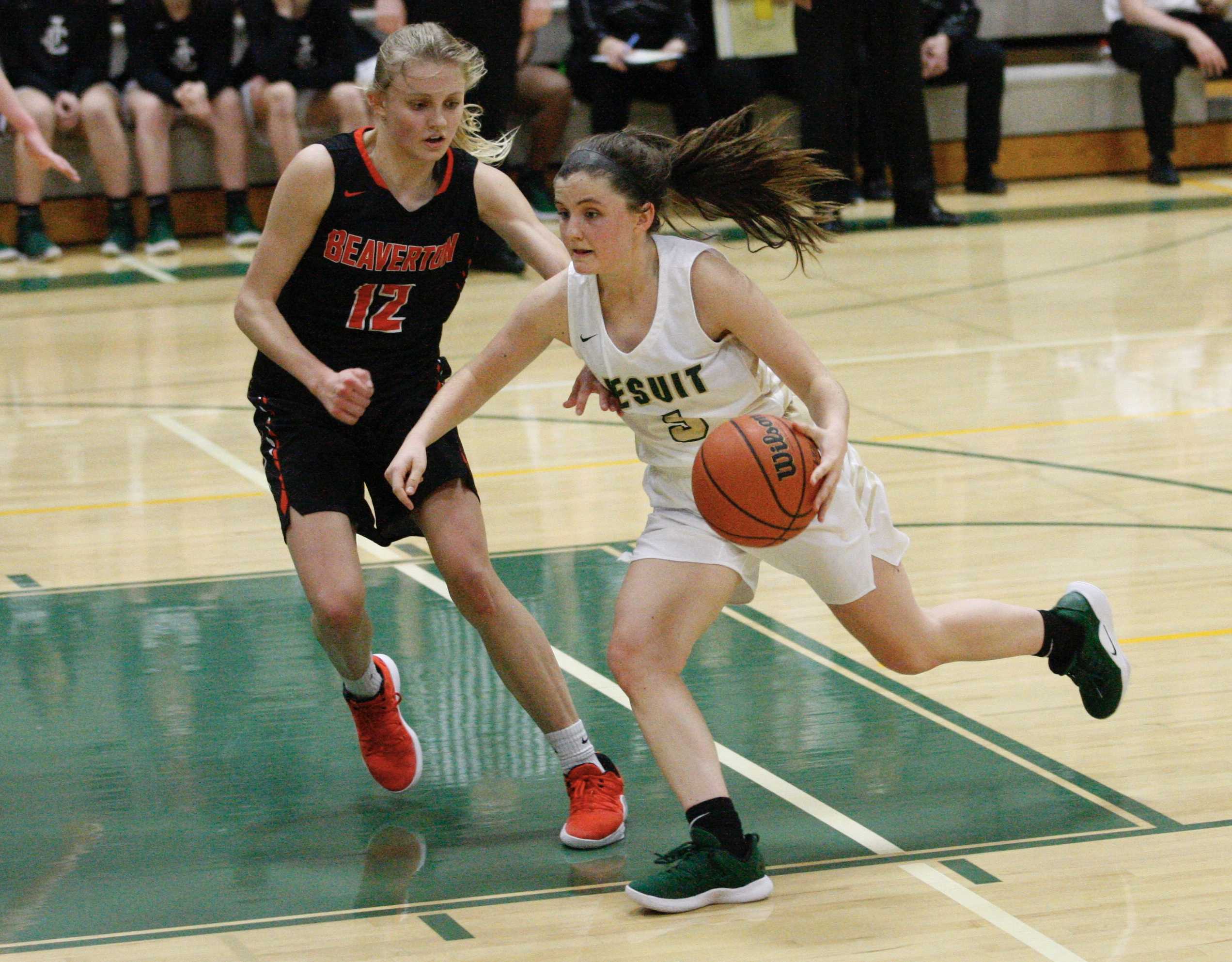 Jesuit guard Anna Fanelli drives on Beaverton's Mary Kay Naro on Wednesday night. (Photo by Norm Maves Jr.0