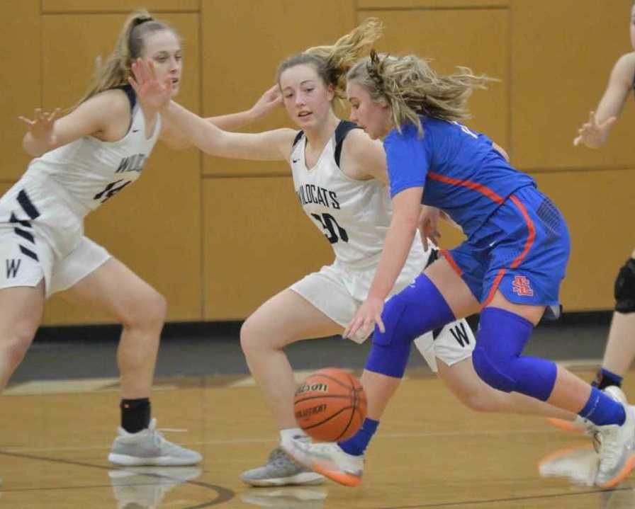 La Salle Prep's Addison Wedin drives against Wilsonville's Kayla Hieb (30) and Emilia Bishop (14). (Photo by Derrick Drango)