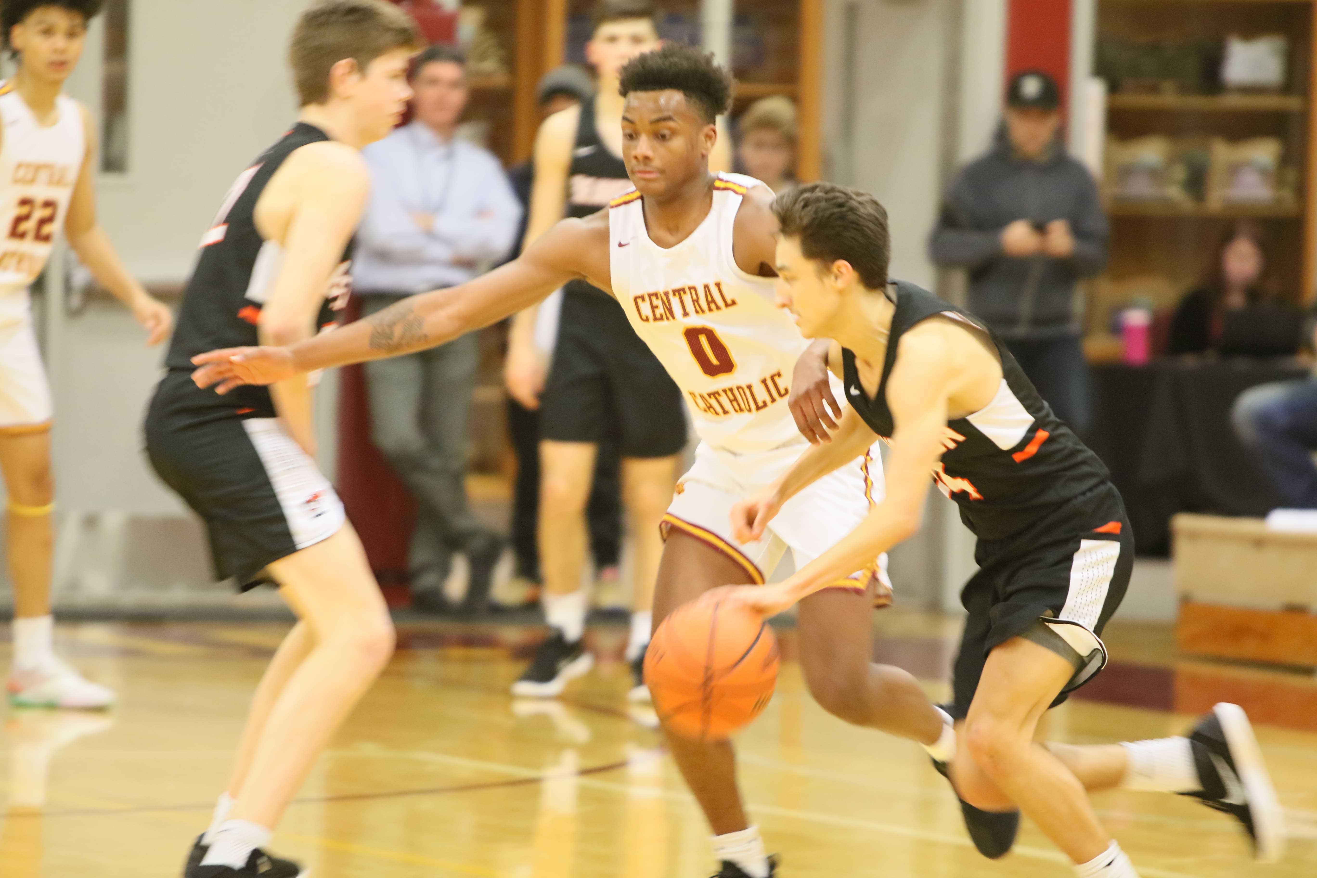 Central Catholic's DeRay Seamster (0) guards Beaverton's Mason Stewart-Carothers. (Photo by Jim Nagae)