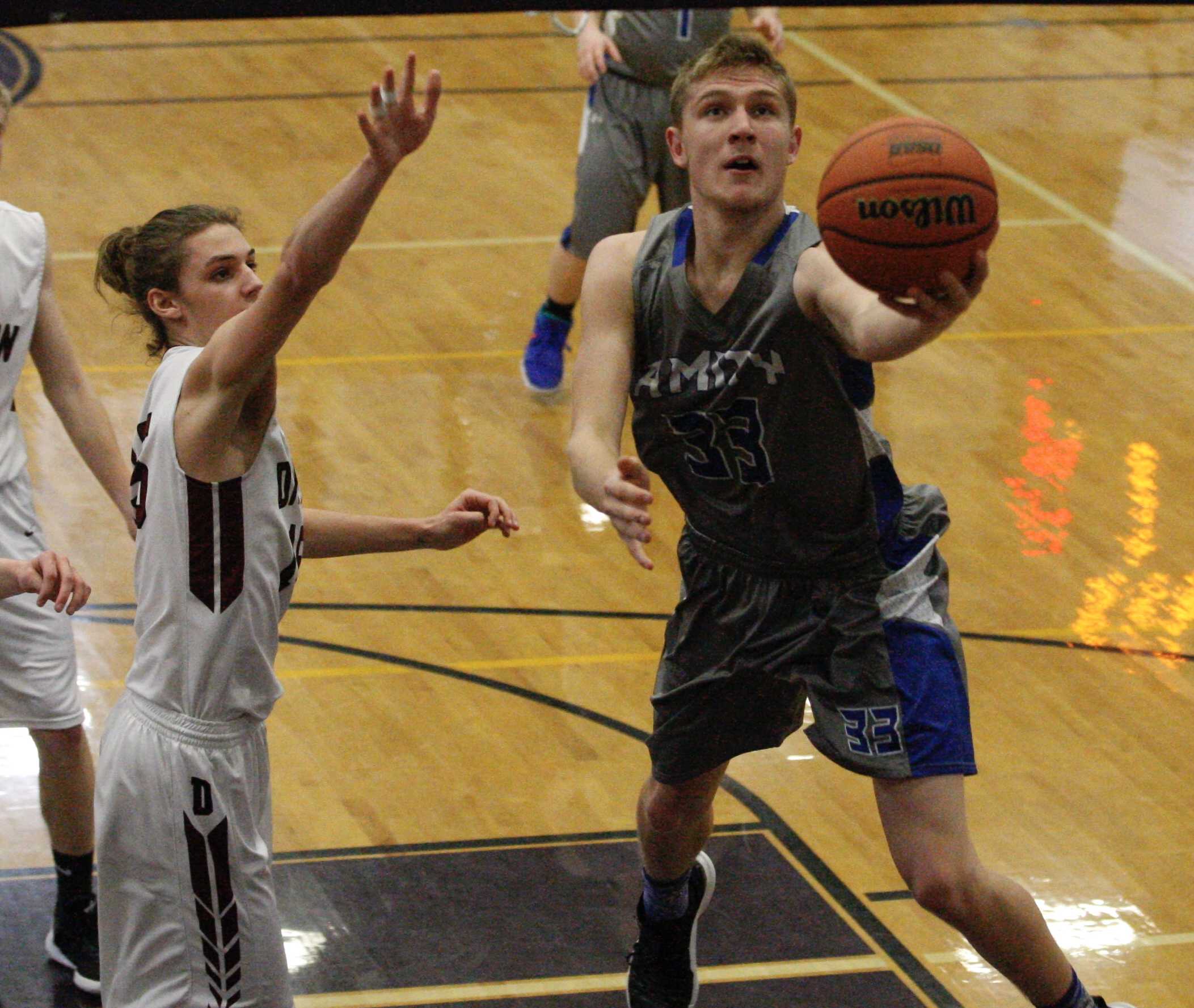 Amity's Josh Wart scoops for two points past Dayton defender in Warriors' dramatic semifinal win. (Norm Maves Jr.)