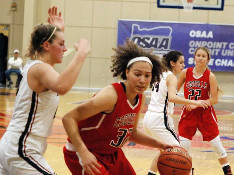 Coquille standout Morgan Baird works against Kenendy's Sophia Carley in the second half of an epic struggle.