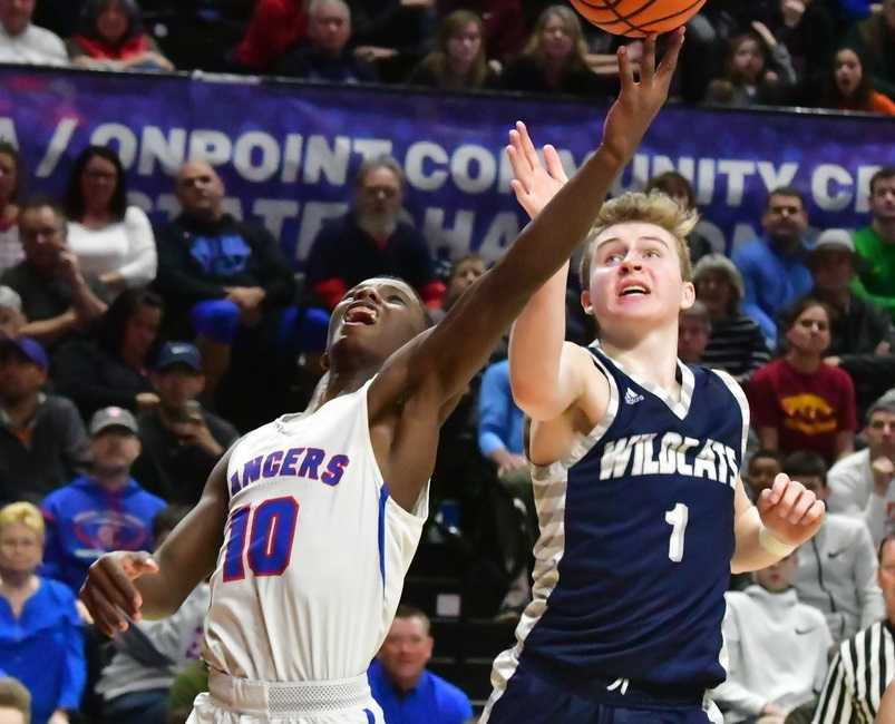 Churchill's Samaje Morgan (10) drives for a layup against Wilsonville's Gabe Reichle (1). (Photo by Joe Richter)