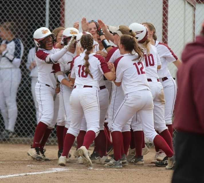 Junction City players celebrate Lindsey Stripling's home run against Marist Catholic. (Photo by Dawn Barth)