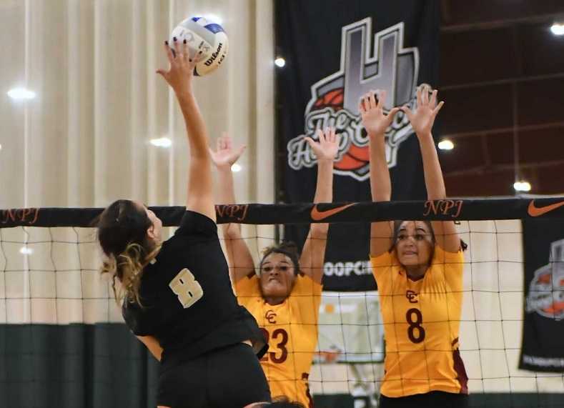 Jesuit's Maddy Dowdall hits against Central Catholic's Makenah Jackson (23) and Marianna Payne (8). (Photo by Ed McReynolds)