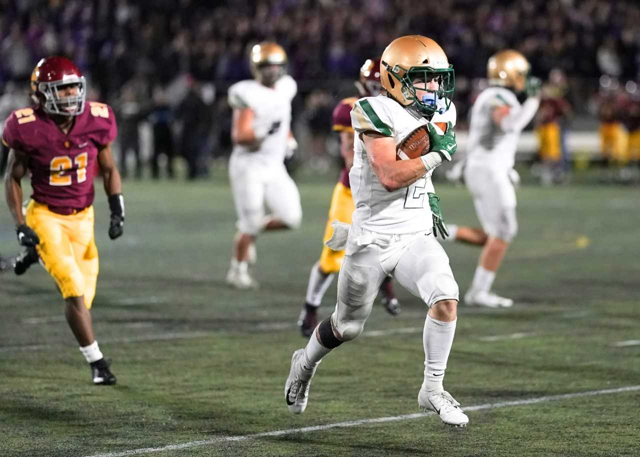 Jesuit's Kade Wisher breaks free for one of his four touchdown runs Friday night. (Photo by Jon Olson)