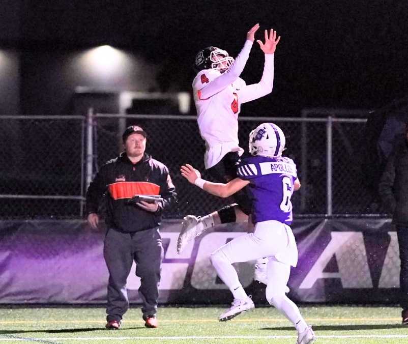 Beaverton's Trent Walker goes up for a pass against Sunset's Kyle Jaekel (6). (Photo by Jon Olson)