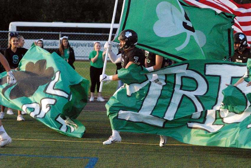 Parker Wiles carries the banner for the Sheldon Irish before Friday's game versus West Linn.